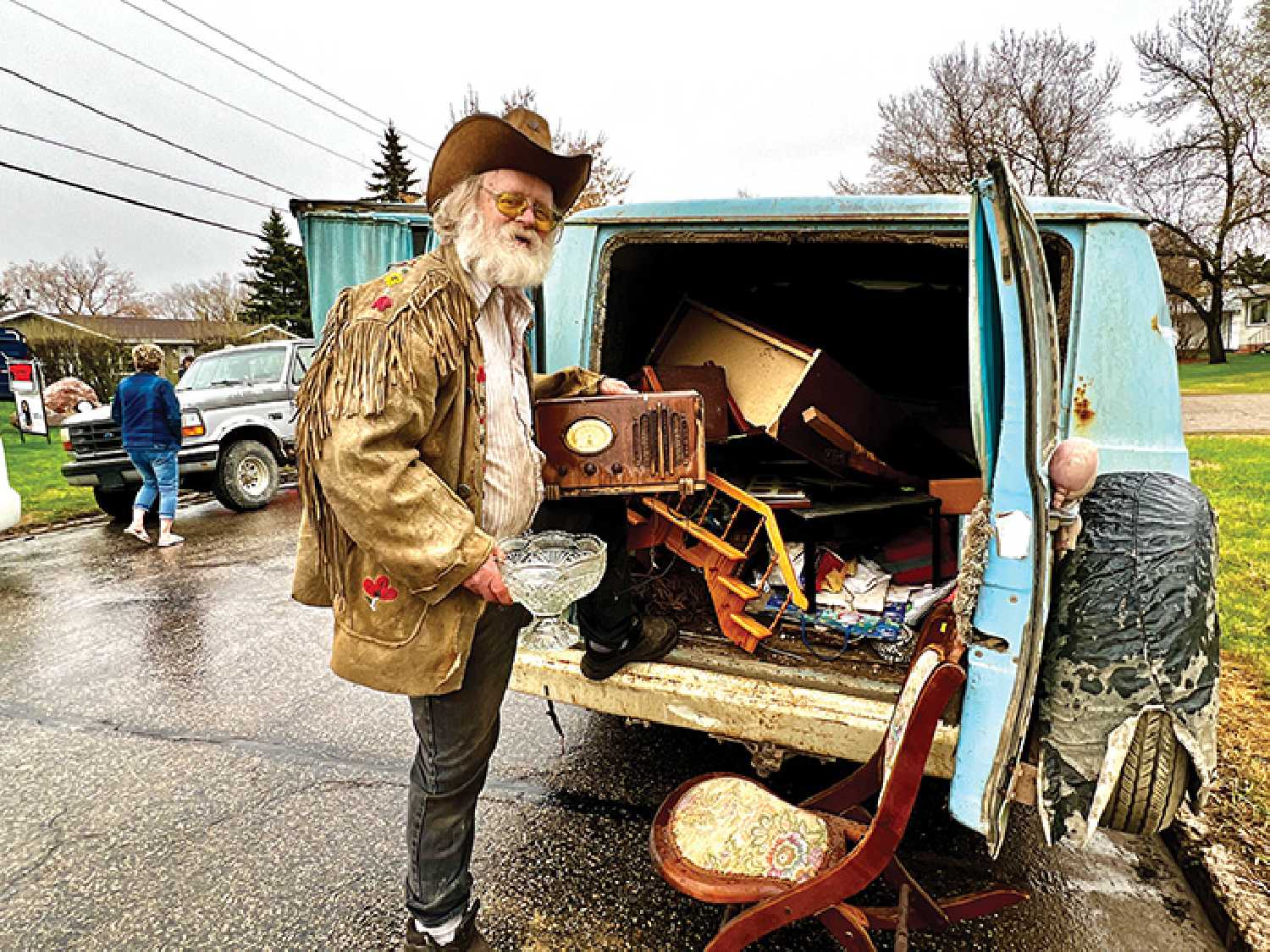George Chopping from Whitewood with a radio, glass bowl, and antique chair that he purchased.